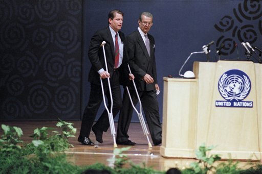 Vice President Al Gore, walking with the aid of crutches due to a sports injury, approaches the podium to address the opening session of the conference in Cairo, Monday, Sept. 5, 1994.
