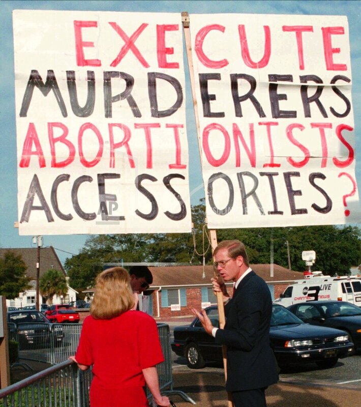 Anti-abortion activist Paul Hill, right, is shown on Feb. 28, 1994, as he confronted a female passerby outside the judicial center in Pensacola, Fla. There is an uneasy calm with increased security at abortion clinics in Pensacola, a year after Hill gunned down an abortion doctor and his escort